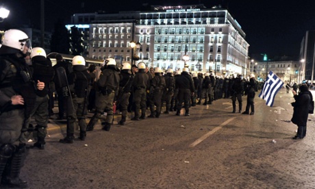 Police surround gathering demonstrators in front of the Greek parliament in Athens last night.