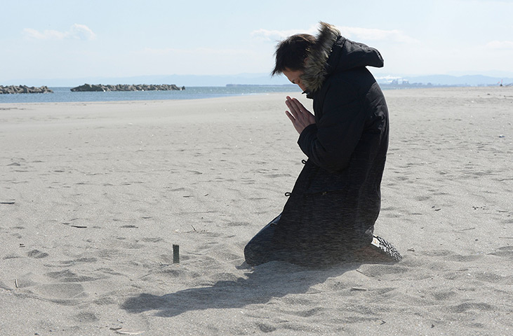 Japan anniversary: A man prays for his friend killed by the tsunami at Arahama district