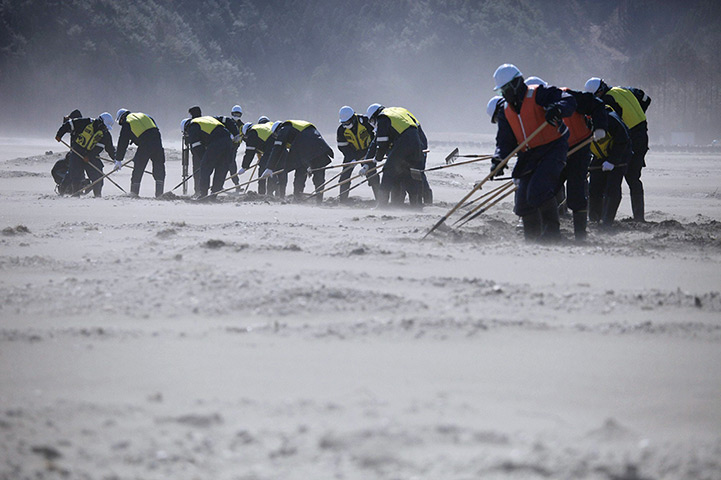 Japan anniversary: Police officers continue to search for tsunami victims