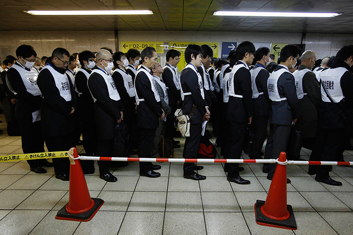 Japan anniversary: Participants observe a moment of silence during a disaster drill