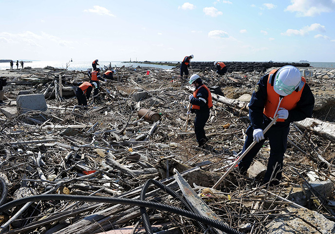 Japan anniversary: Police officers search for tsunami victims