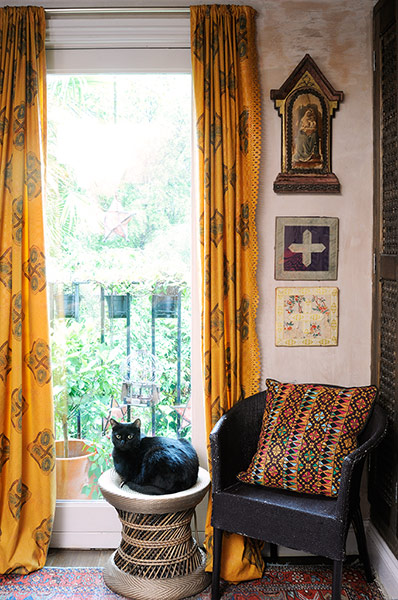 Homes - moroccan home: cat sitting on stool in front of large window