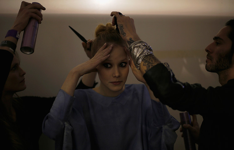 24 hours in pictures: A model prepares backstage during Lisbon fashion week