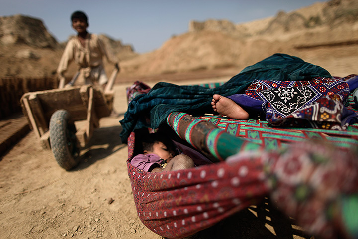 24 hours in pictures: : Pakistani children sleep in a hammock and bed in a brick factory