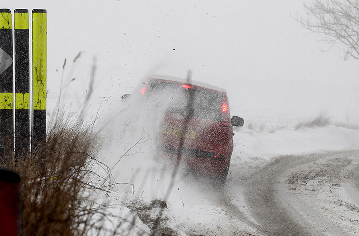 Spring snow: A driver loses control of their car on Farthing Common near Folkestone