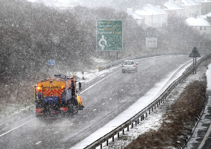 Spring snow: A lorry spreads salt on the A20 near Dover, Kent 