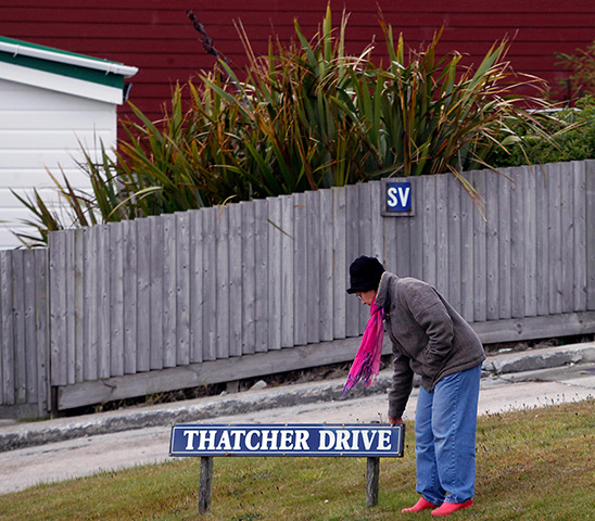 Falkland Islands: A woman touches the Thatcher Drive sign in Stanley