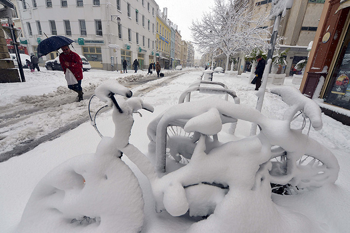 Europe snow: Snow covers bicycles in Cherbourg