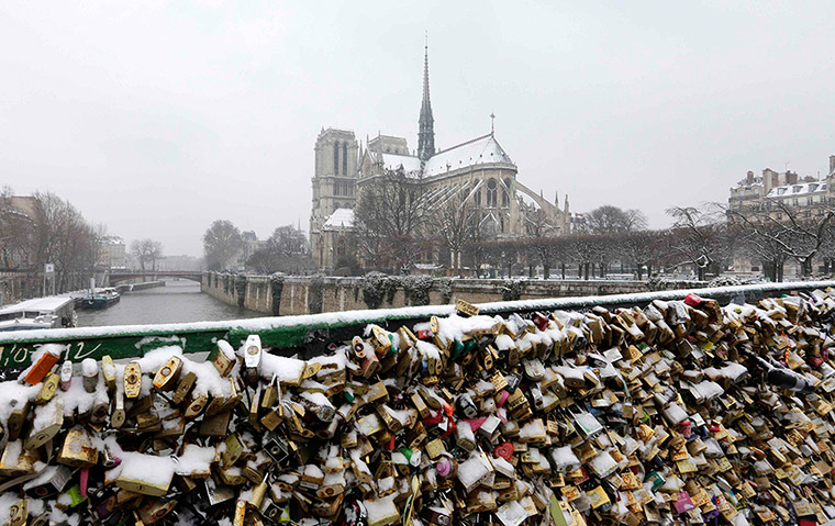 Europe snow: Snow covers padlocks clipped to the Pont de l'Arceveche bridge 