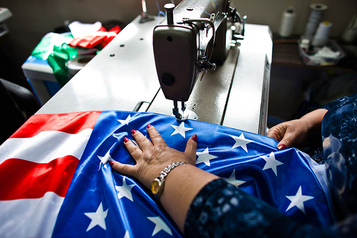 24 hours in pictures: A worker at a factory in Kfar Saba sews U.S. flags