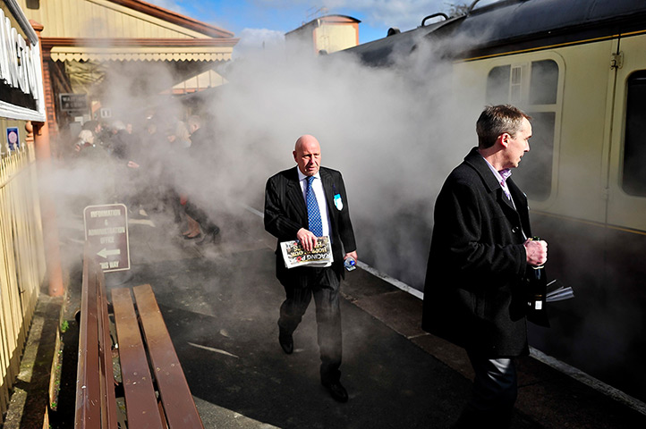 24 hours in pictures: Cheltenham racegoers pass steam train