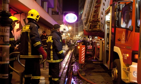 Firefighters outside the office of Greek deputy Environment Minister, Stavros Kalafatis  after an explosion in Thessaloniki, northern Greece.