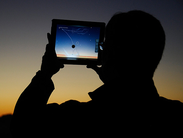 24 hours: Los Angeles, USA: Aman uses an iPad to line up a comet