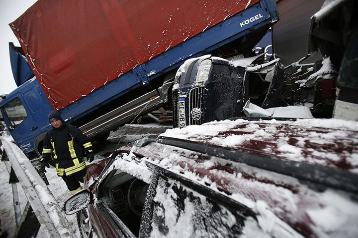 24 hours: Muenzenberg, Germany: A rescue worker stands next to wreckag