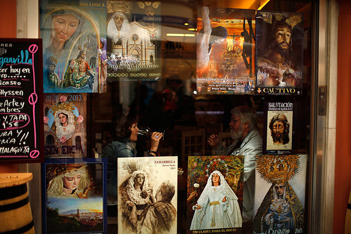 24 hours: Malaga, Spain: Tourists sit in a restaurant
