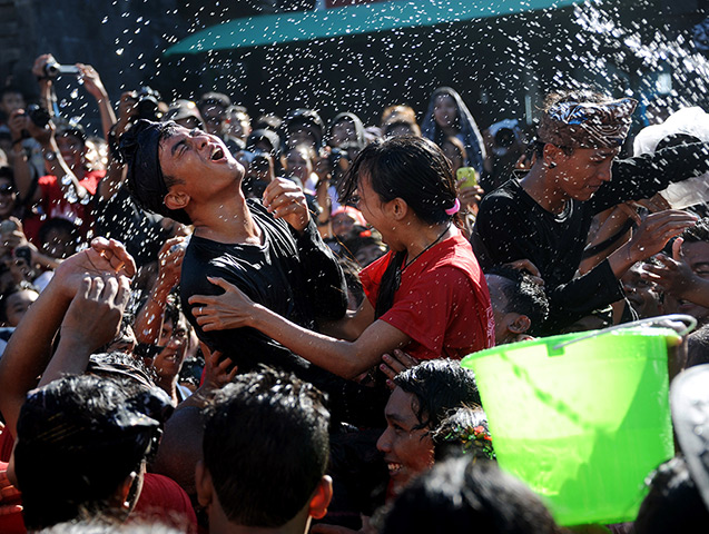 24 hours: Denpasar, Bali: A young couple react at a kissing festival