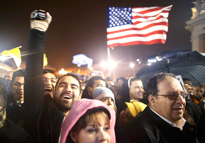 Pope elected gallery: Faithful cheer near a U.S. flag 