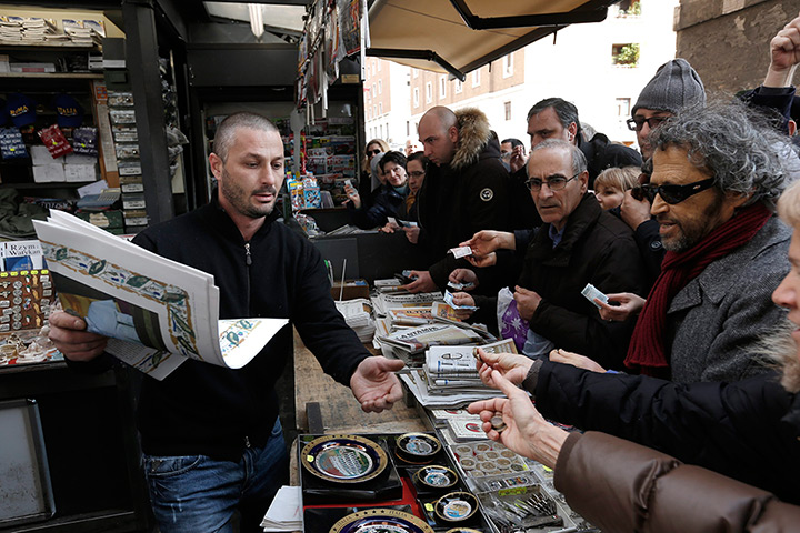 Pope Francis first day: vendor sells newspapers of the newly elected Pope Francis I