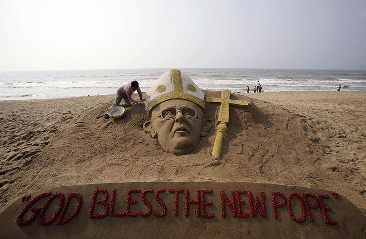 Pope Francis first day: Finishing touches to a sand sculpture of the new pope