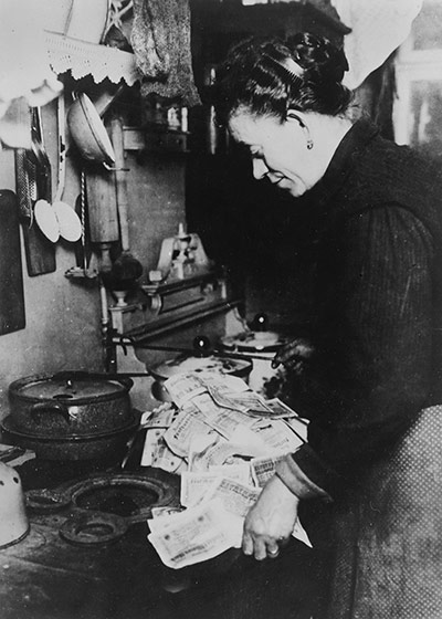 Rest is Noise Berlin 1920-33: woman burning money