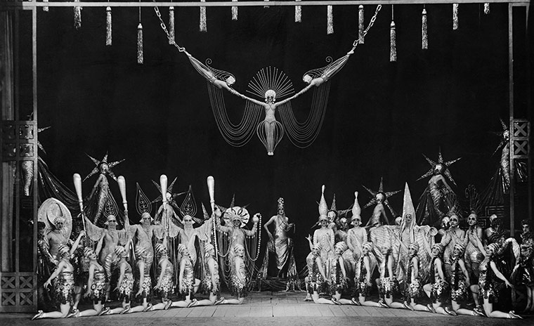 Rest is Noise Paris: Dancers and showgirls fill the stage during a revue at the Folies-Bergeres