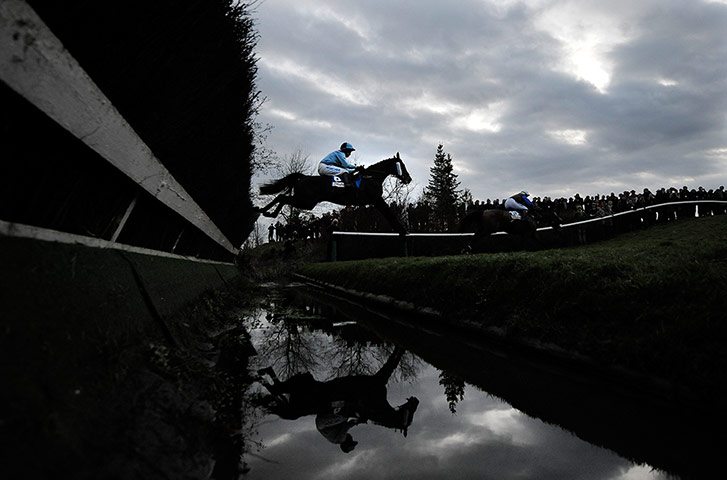 Cheltenham day 3 part 2: Runners in the cross-country race jump the water ditch