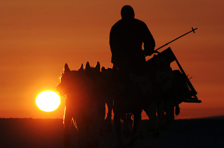 Best of the week: Paul Gebhardt tilts his dog sled onto one runner