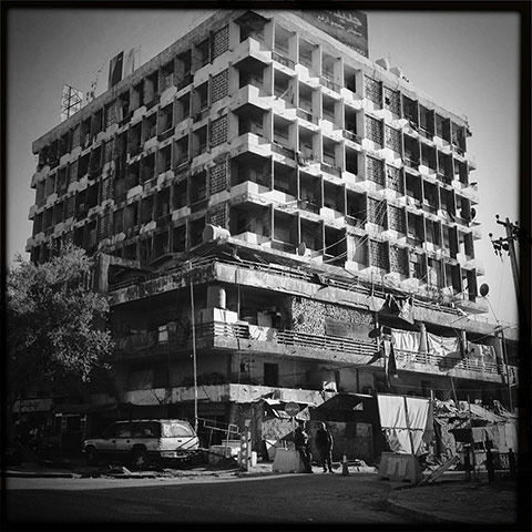 Baghdad: Two policemen guard a typical central Baghdad apartment block