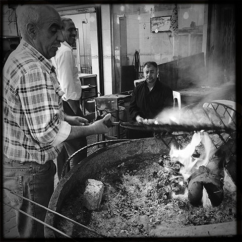 Baghdad: A street vendor grills carp for masgouf