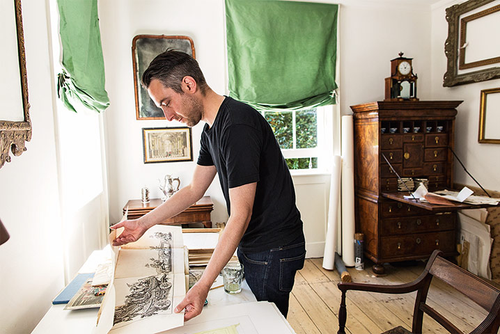 The Selby: Pablo in the study with a fold-out book