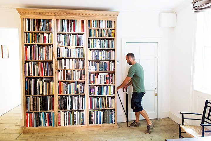 The Selby: Leo next to the bookcase in the sitting room