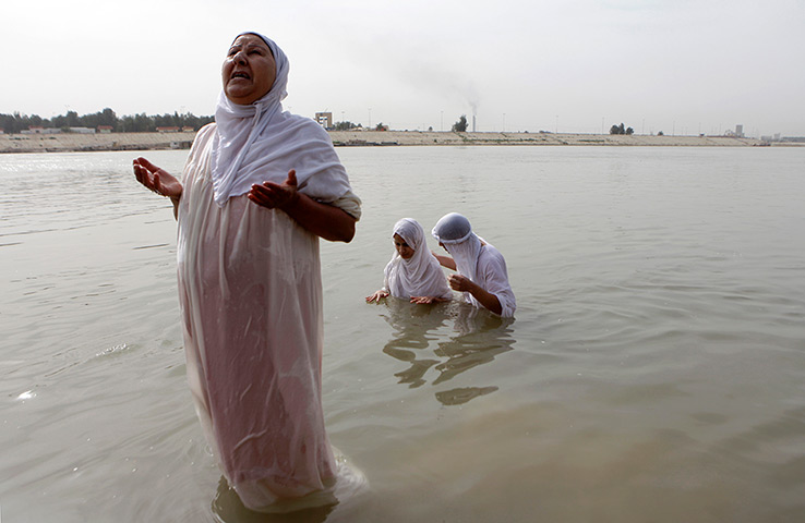 24 hours: Baghdad, Iraq: followers of the Sabaean Mandean religious sect bathe