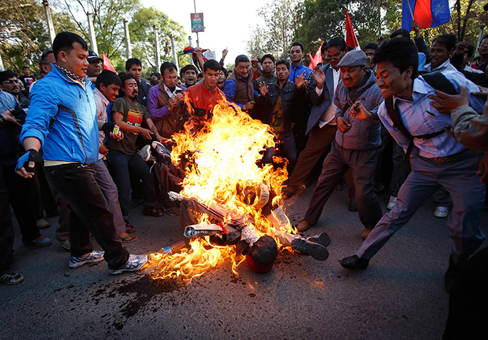 24 hours: Kathmandu, Nepal: Activists burn an effigy of new Prime Minister