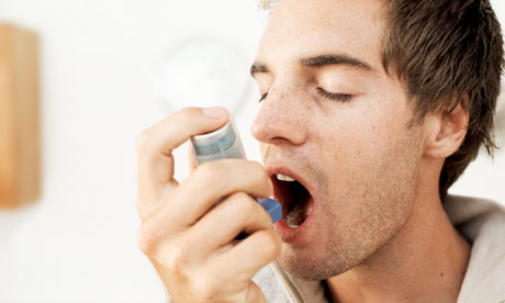 Man using an inhaler