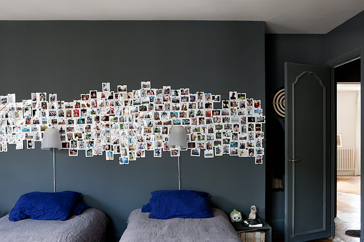 Homes - Paris apartment: grey room with postcards on wall and blue cushions