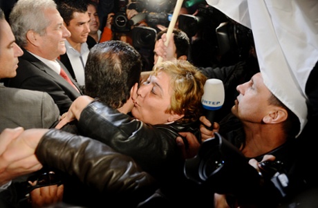 A Cyprian woman celebrates with parliament member after the Cyprus parliament has rejected the bailout deal, during the rally against a tax levy on deposits, in front of the Cyprus parliament in Nicosia, Cyprus, 19 March 2013.