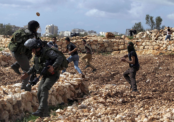 24 Hours:  Palestinian youth throw stones towards Israeli border guards in Bilin