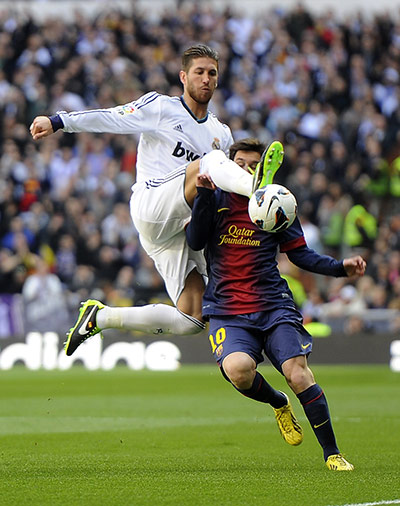 classico: Sergio Ramos clears from Lionel Messi 