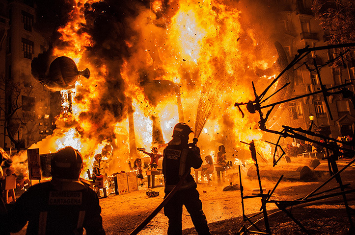 24 hours: Valencia, Spain: Firefighters put out a fire at the Las Fallas Festival