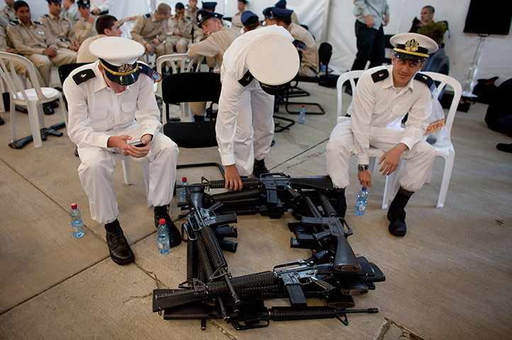 24 hours: Tel Aviv, Israel: Members of the military await Barack Obama's arrival at Ben Gurion airport
