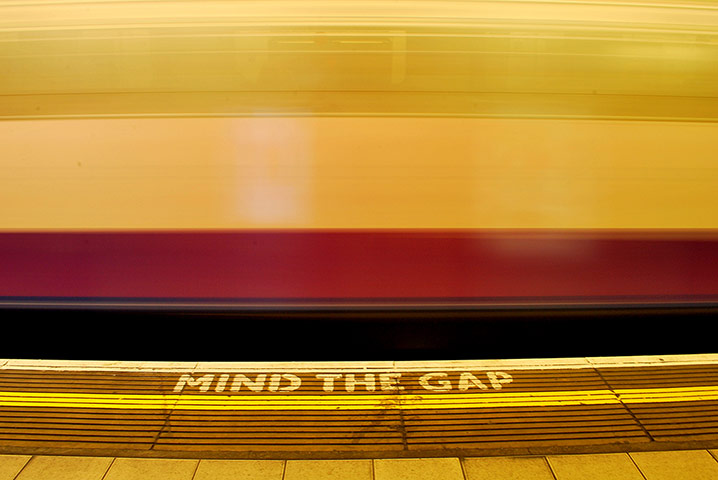 Your pictures - station: yellow, red and black mind the gap sign on platform