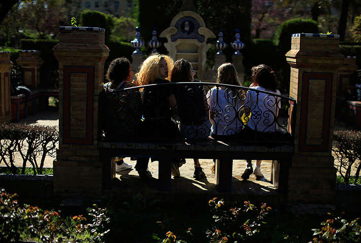 24 hours in pictures: Tourists sit on a bench at the Plaza de America 