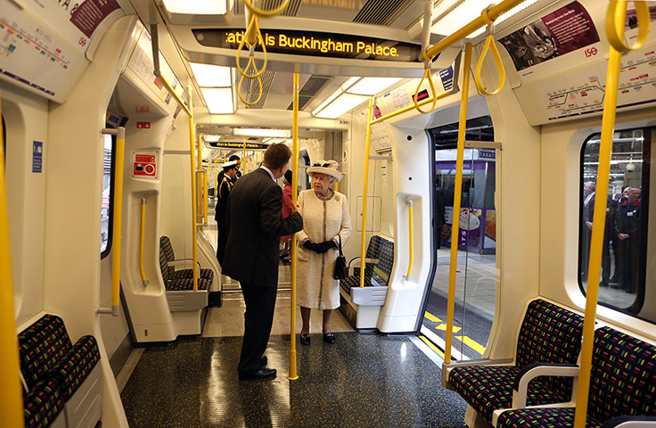 24 hours in pictures: Queen Elizabeth II stands onboard a tube 