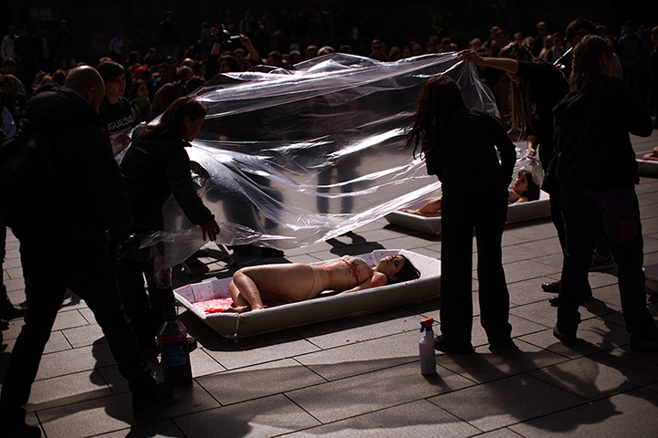 24 hours in pictures: Animal rights activist from the group covered with plastic sheets