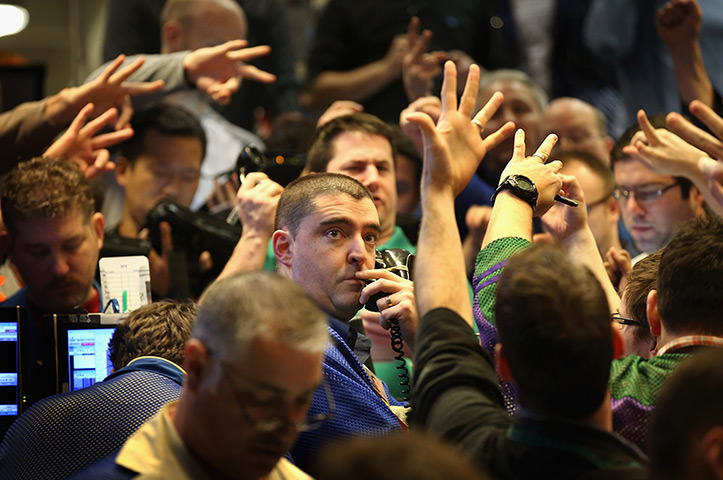 24 hours in pictures: Traders signal offers at the Chicago Board Options Exchange