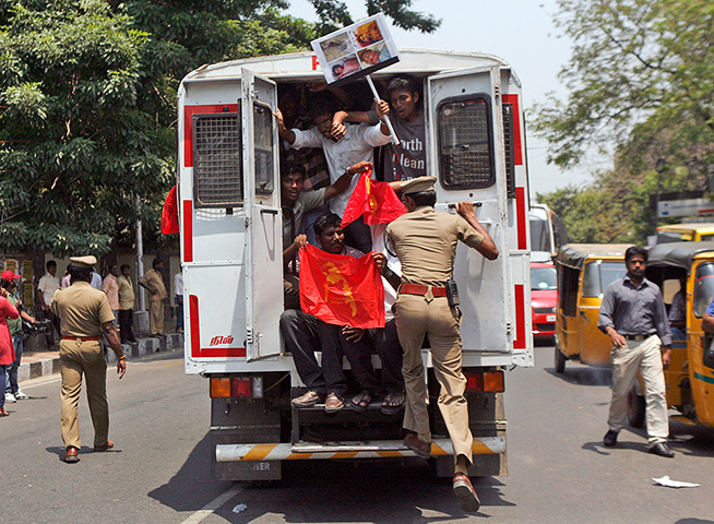 24 hours in pictures: Indian Tamil activists and supporters shout slogans inside a police van