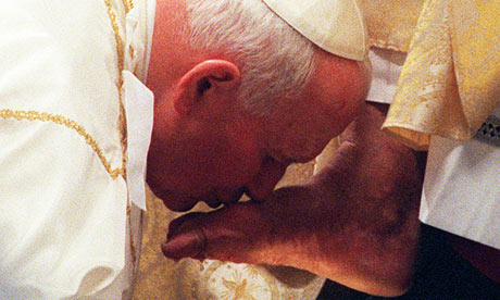 Pope John Paul II kisses the foot of a clergyman during the Holy Thursday ceremony at St Peter's