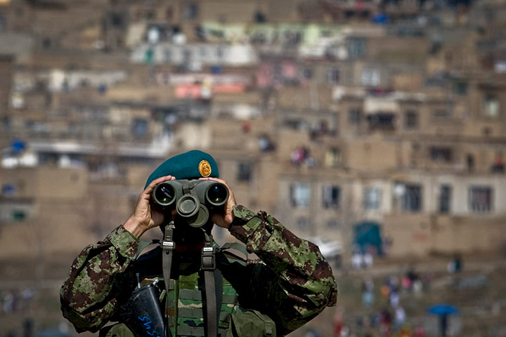 24 hours: Kabul, Afghanistan: A policeman stands guard near the Kart-e Sakhi mosque