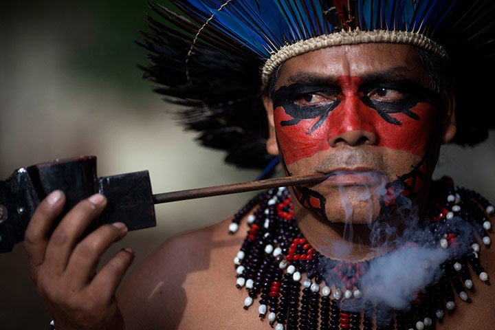 24 hours: Rio de Janeiro, Brazil: An indigenous man smokes a pipe