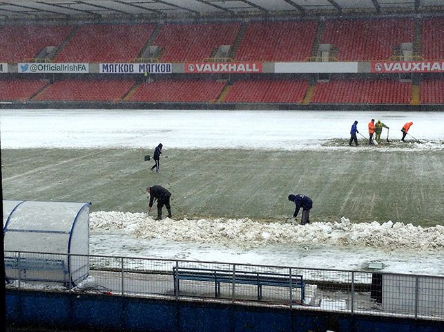 Uk snow: Ground staff help clear snow away from Windsor Park